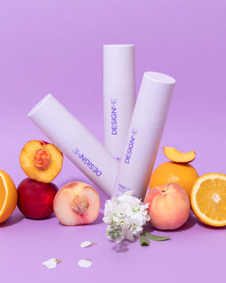 Image of three FAB.ME Leave-In Treatments surrounded by fresh nectarines, peaches, and flowers
