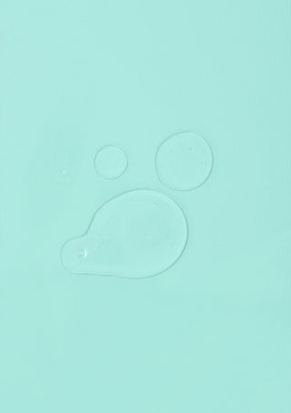 Close-up of GLOSS.ME Hair Oil highlighting its clear, glossy, and lightweight formula.