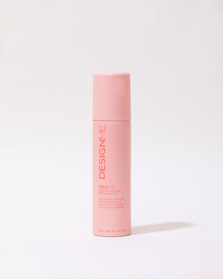 Front view of travel-size HOLD.ME Three-Way Hairspray bottle, compact and sleek design.