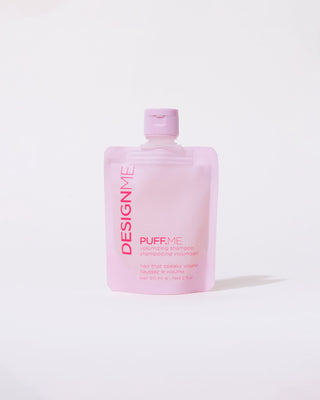 front view of a pink pouch of PUFF.ME volumizing shampoo discovery size with a pink dispenser top, placed against a white background.