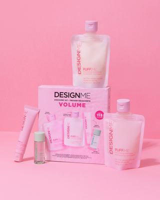 DESIGNME Volume Discovery Kit on pink background, featuring PUFF.ME shampoo, conditioner, mask, and hair oil.