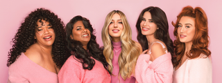 Diverse models with different hair textures and colors in pink clothing, flaunting smooth, voluminous, and healthy hair on pink backdrop.